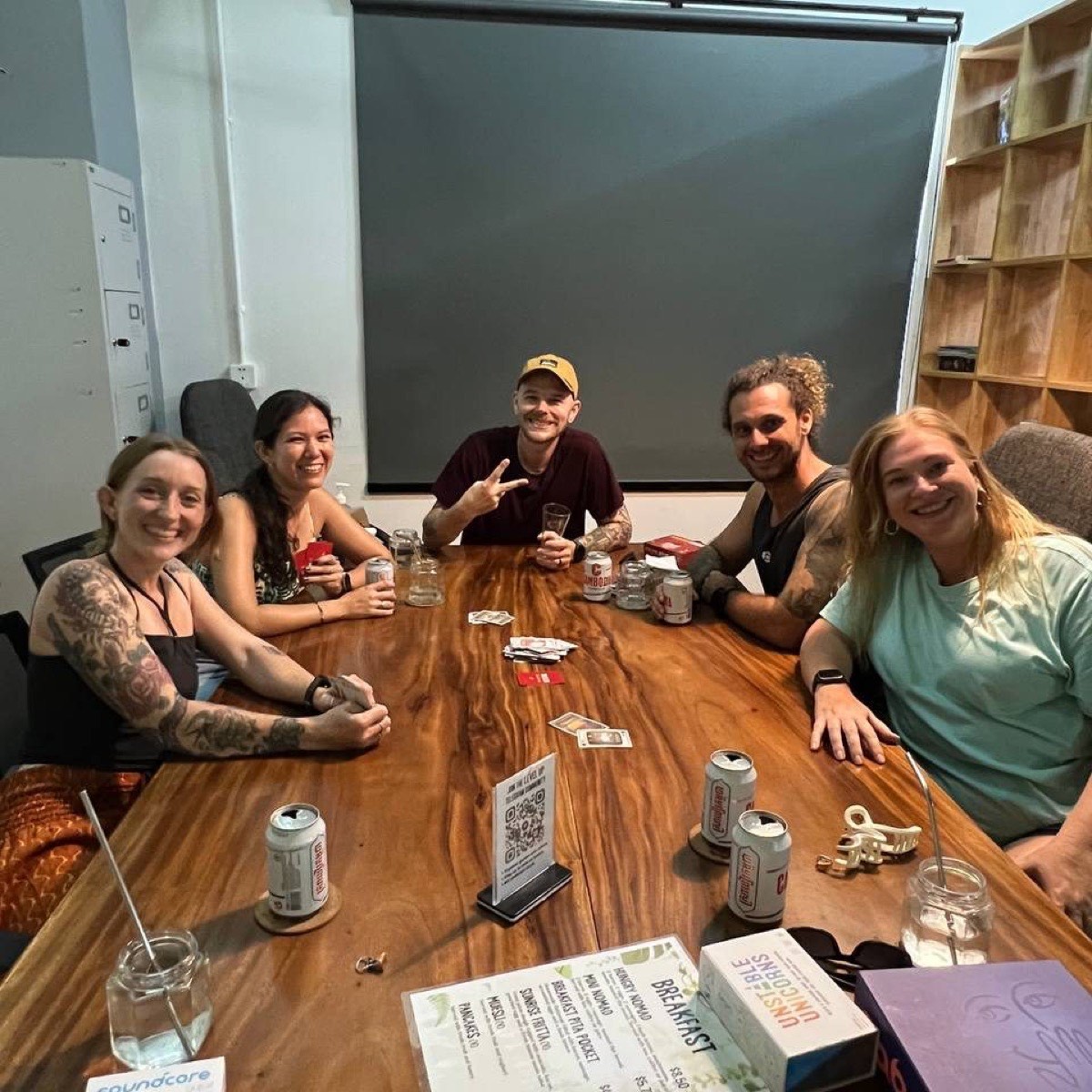 A group of friends laughing over a card game at Level Up